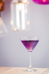 Violet or Purple Cocktail with Sequins, Margarita or Daiquiri Cocktail in Bar, Vertical View