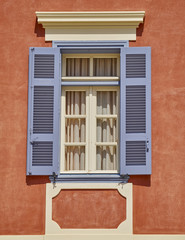 Fototapeta na wymiar elegant vintage window on orange house wall