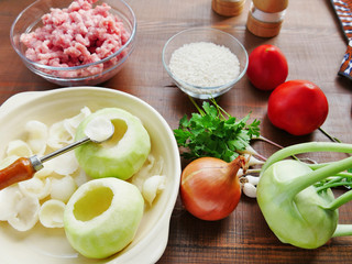 Ingredients for cooking stuffed kohlrabi on wooden table