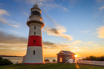 Low head lighthouse, Tasmania at sunset with sunstar - obrazy, fototapety, plakaty