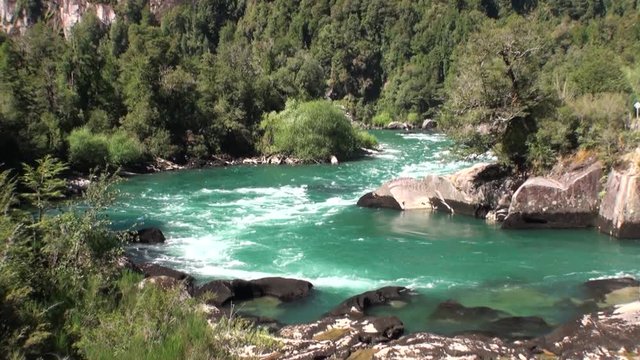 River in green mountains show power water in Patagonia Argentina. Unique landscape of wildlife. Beautiful nature background. Travel and tourism in picturesque world of stone rocks and hills.