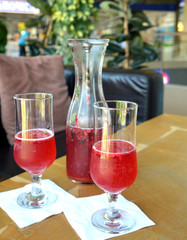 Summer lemonade with raspberry and leaves mint in a glass jug