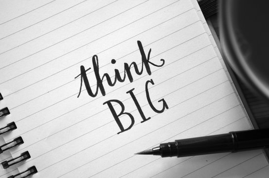 THINK BIG motivational quote written in notebook