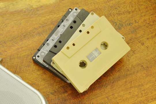 cassette tape recorder and radio loudspeaker on wooden table