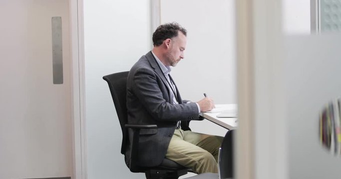 Male Medical Doctor working in his office