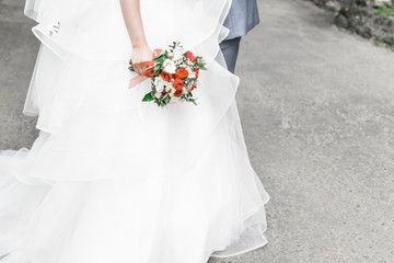 The bride is holding a wedding bouquet