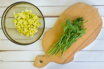 Preparation of a vegetarian salad. Cutting fresh arugula