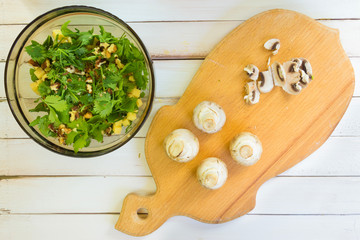 Preparation of a vegetarian salad. Slicing fresh mushrooms of champignons