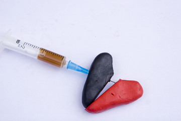 Needle pierces a broken heart