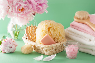 Fototapeta na wymiar bath and spa with peony flowers brush sponge towels