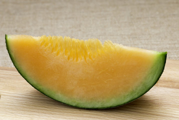 Fresh melons sliced on wooden table