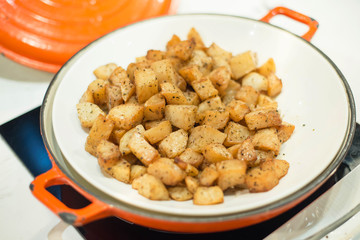 Fried potatoes in pan.