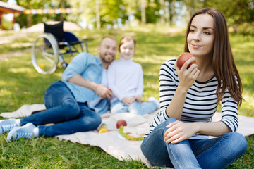 Beautiful smiling brunette going to eat apple