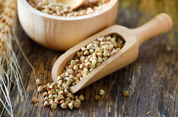 Buckwheat in wood scoop on table