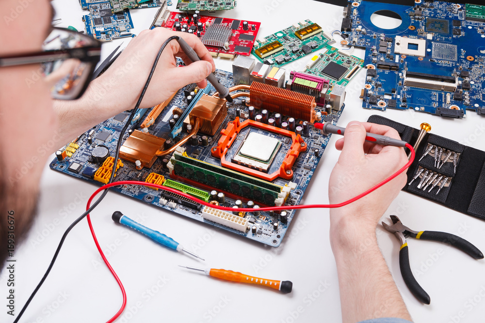 Poster engineer checking motherboard with multimeter
