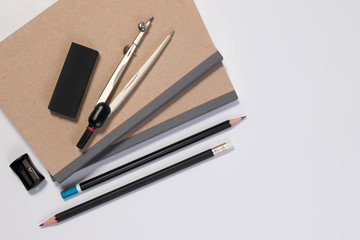 Mathematics math desk or math office supplies. Education math workplace with pen, notebook, divider compass in Mathematics class with white background and copy space for text.