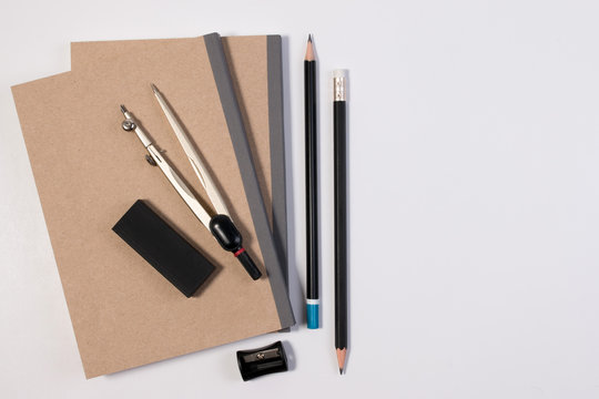 Mathematics math desk or math office supplies. Education math workplace with pen, notebook, divider compass in Mathematics class with white background and copy space for text.