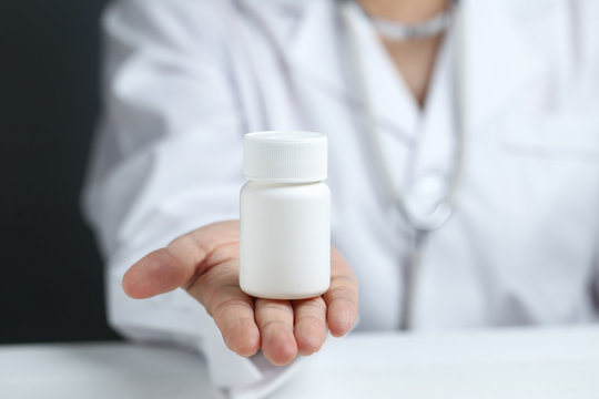 Female Doctor Holding And Showing A Medicine Bottle