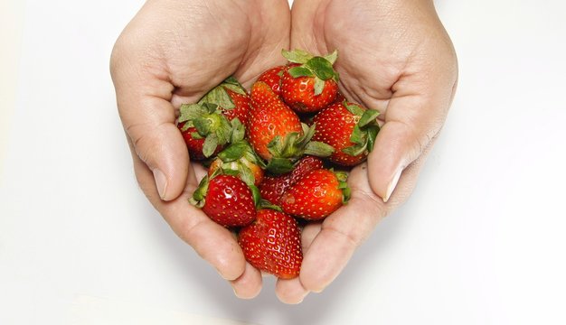 Strawberries in hand palm