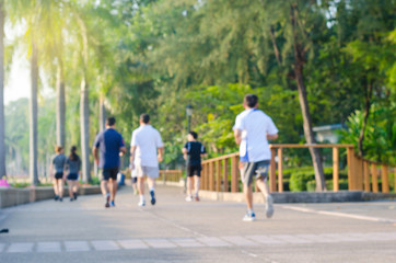 blur people running in the park at morning.