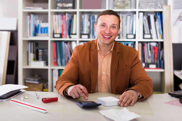 Portrait of smiling manager working in agency office