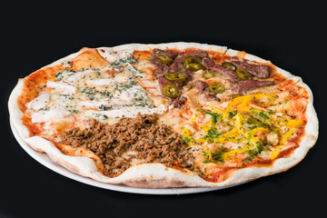 Meat pizza with chicken, beef and sweet pepper on a dark background