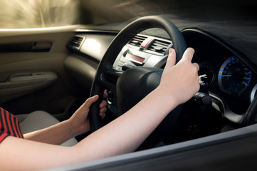 woman hand holding on black steering wheel, woman drive a car