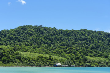 Home wood old in sea and the big mountain at koh kood Thailand