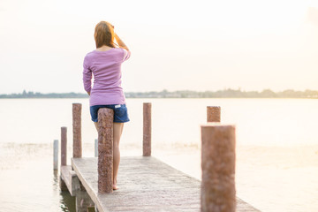 young girl on a wooden bridge