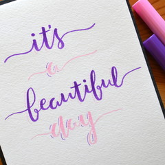 IT’S A BEAUTIFUL DAY hand lettered in notepad