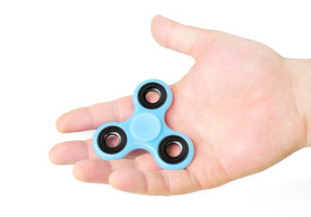 Male hand holding fidget spinner in palm, isolated on white