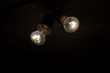 Two retro light bulb in the dark . New ideas