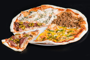 Sliced meat pizza on plate, a dark background. Shallow dof