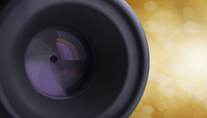 closeup camera lens with blurred bokeh light background.