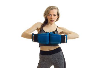 sexy fitness blonde posing in a Studio in boxing gloves