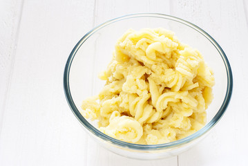 Mashed potatoes in a glass bowl on a table