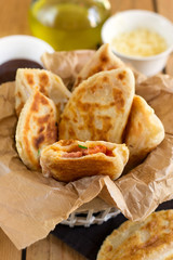 Fried flatbread filled with ketchup, cheese and sausages