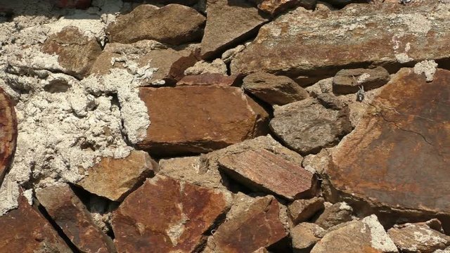 Old rusty horseshoe hanging on the stone wall 
