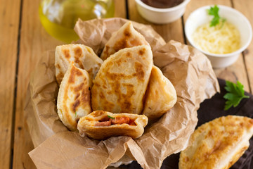 Fried flatbread filled with ketchup, cheese and sausages