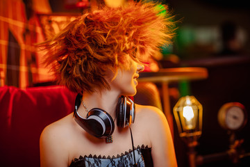 Girl in headphones at the disco