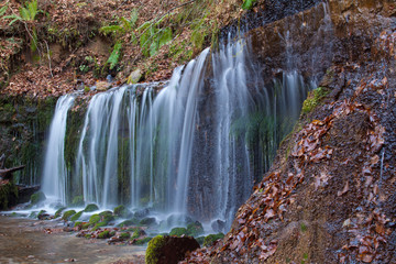 Fototapeta na wymiar Shiraito Waterfall in autumn season , is located in the forests north of downtown Karuizawa , Japan