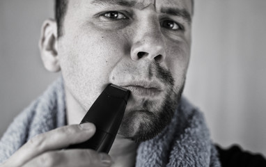 monochrome textured portrait bearded man shaving