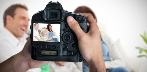 Composite image of cropped image of hands holding camera 