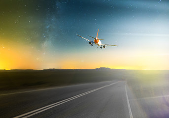 Fototapeta na wymiar Airplane flying over roadway