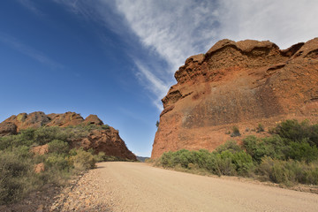 Dirt road leading over a high mountain pass in daytime