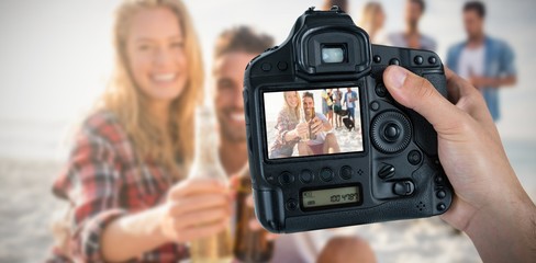 Naklejka premium Composite image of cropped hand of photographer holding camera 