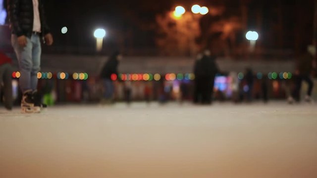 Moscow. Skating rink in the open air. People skate in the winter. Evening time. Christmas lights.