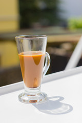 milk coffee in modern glass on white table, copyspace
