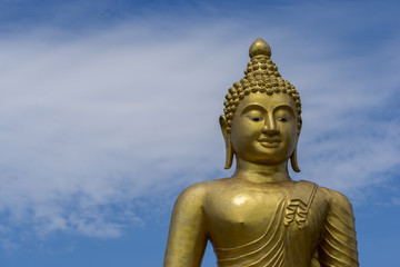 Golden Buddha Statue in Phuket; Thailand with blue sky background