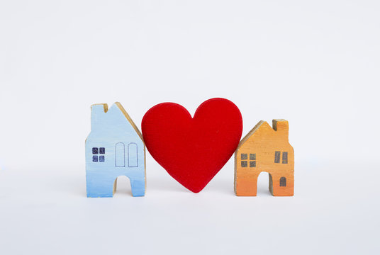 Wooden miniature house with red heart isolate on white background, property and real estate concept business
